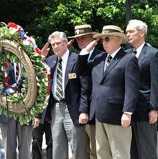 Veterans salute in Rocky Versace Plaza.