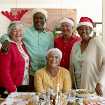 Image of seniors smiling and dressed at a holiday party.