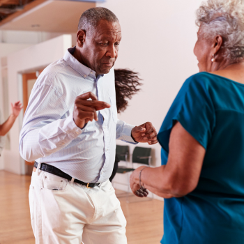 Image of seniors smiling and dancing.